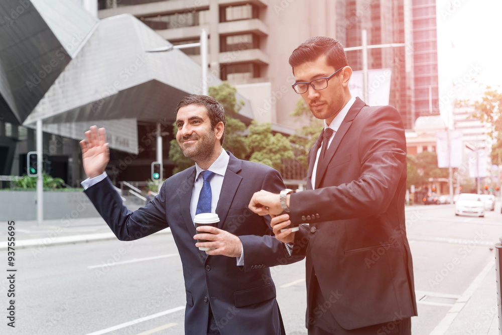 Businessmen catching taxi