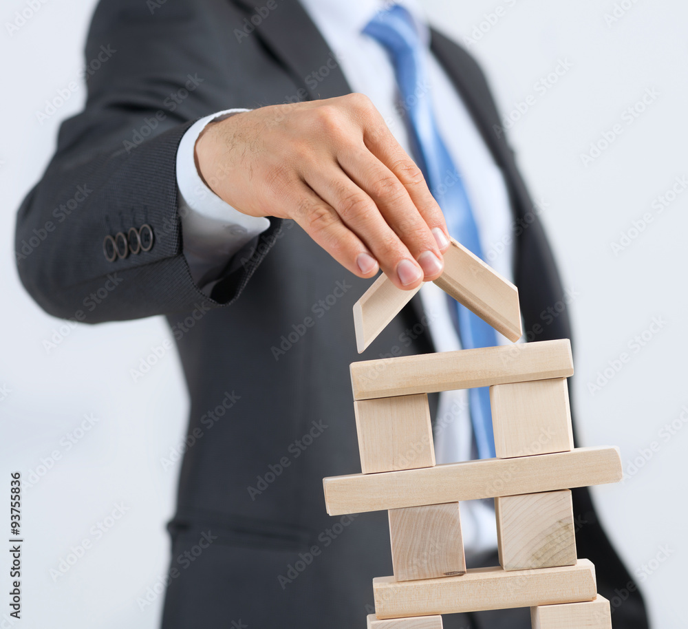 Businessman making tower