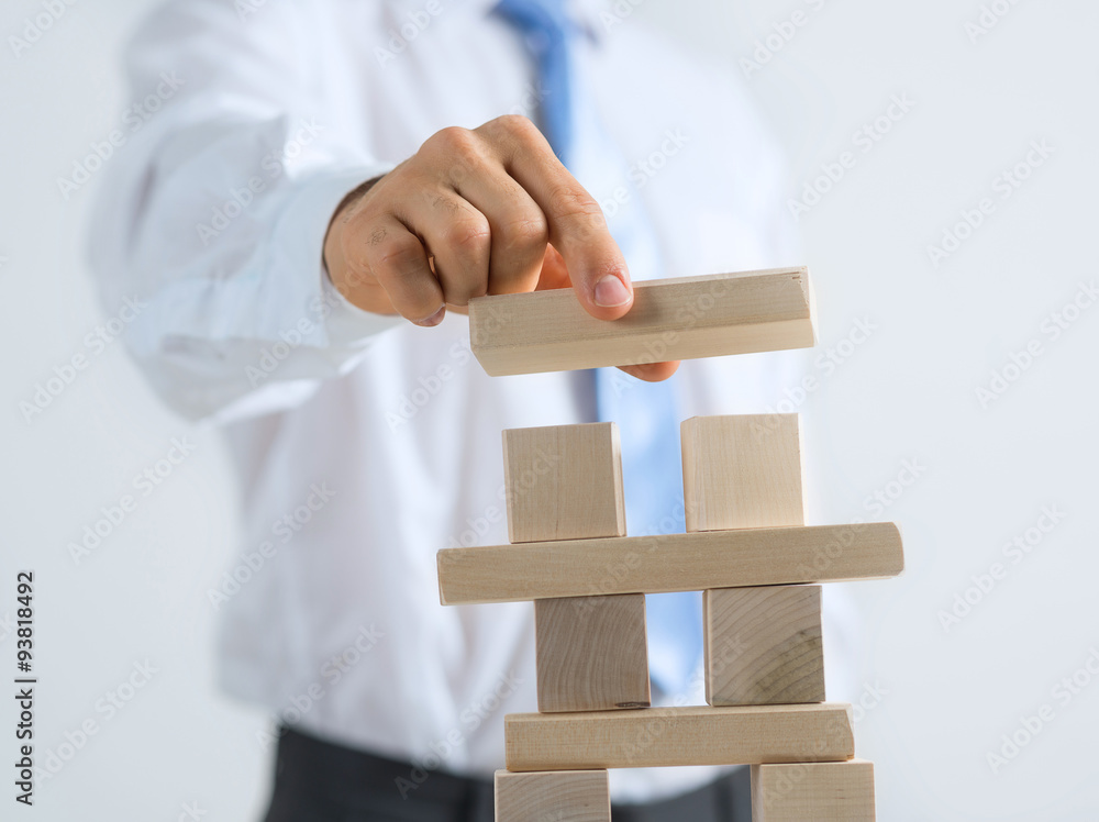 Businessman making tower