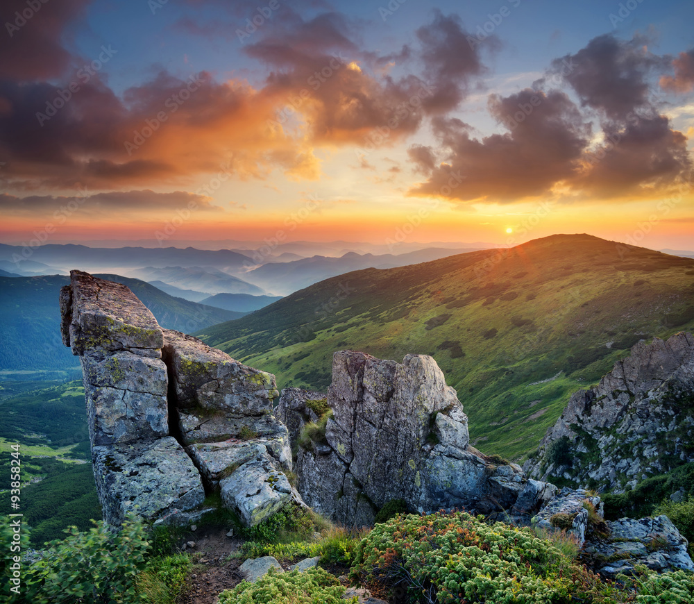 High rocks in mountain valley during sunrise. Natural summer landscape