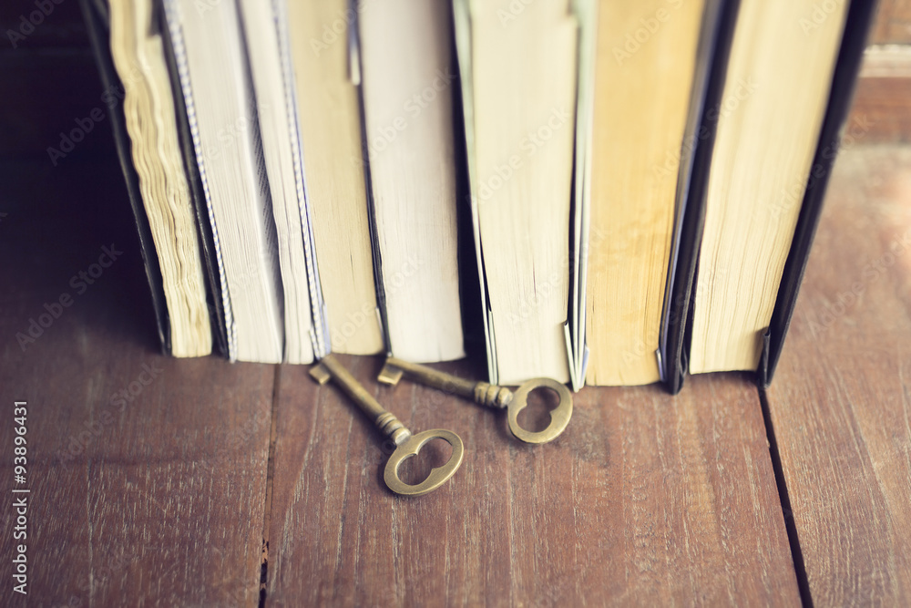 Books and keys on a wooden floor