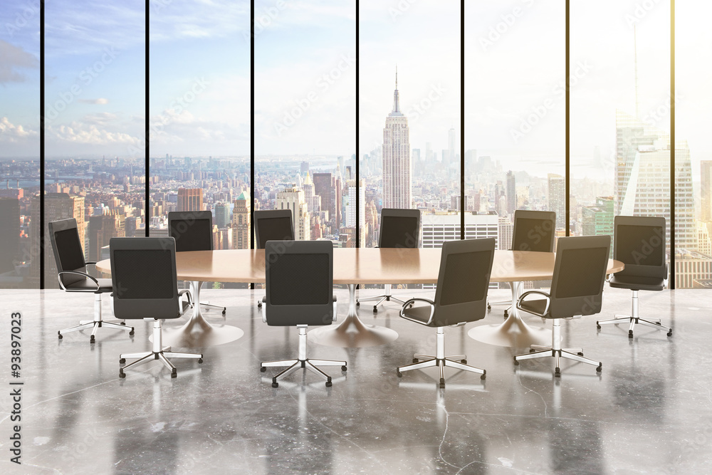 Conference room with round table, chairs, concrete floor, window