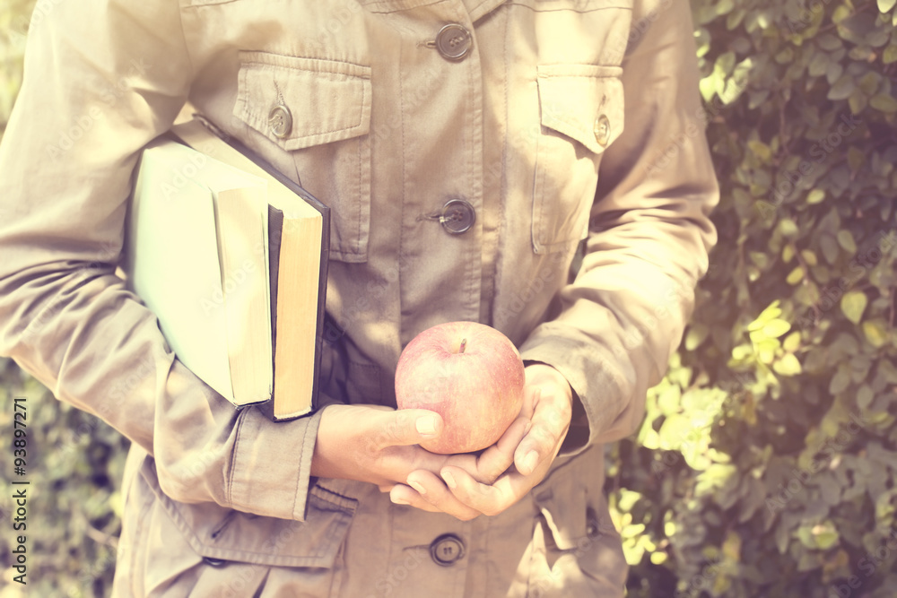 Girl with books and an apple, vintage photo effect