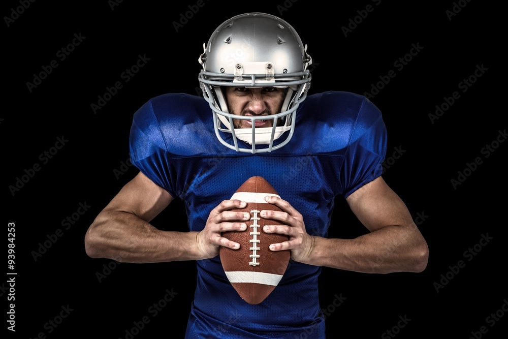 Aggressive american football player holding ball