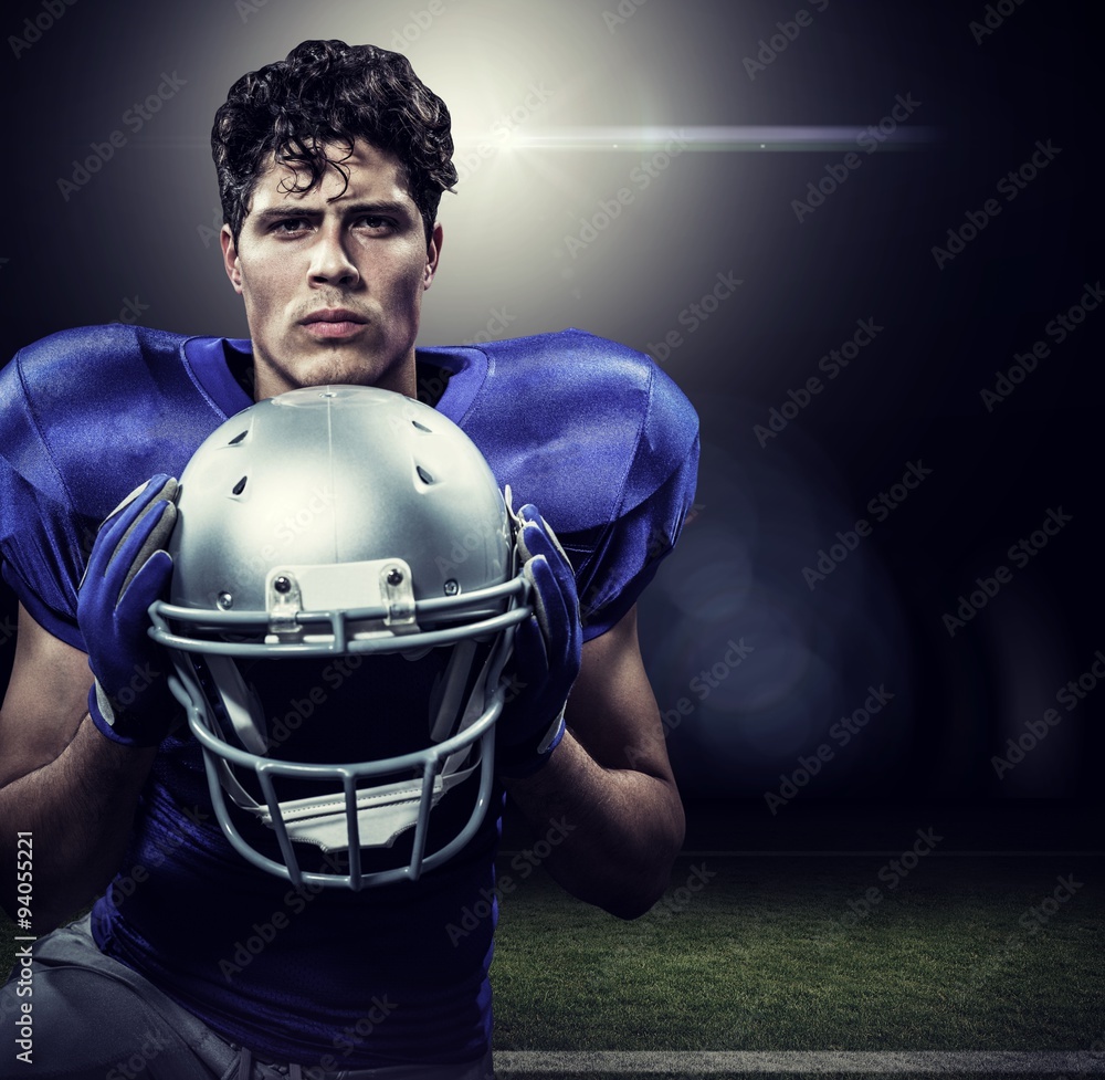 Composite image of sportsman holding helmet