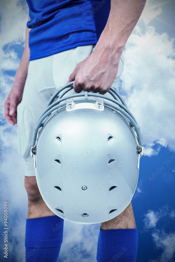 Composite image of sports player handing his helmet