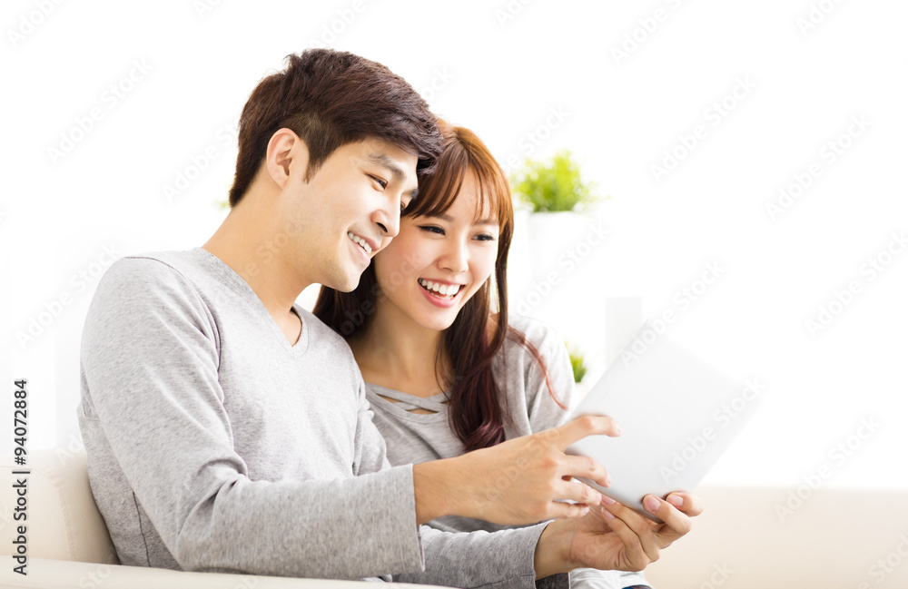 happy  Couple Looking at tablet In living room