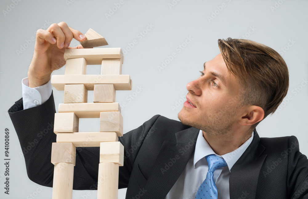 Businessman making tower