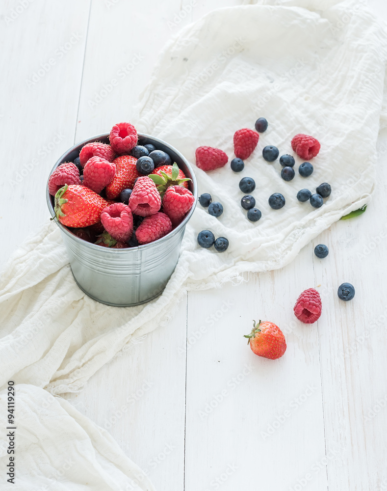 Metal bucket of strawberries, raspberries, blueberries and mint