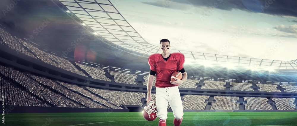 American football player walking with ball and helmet