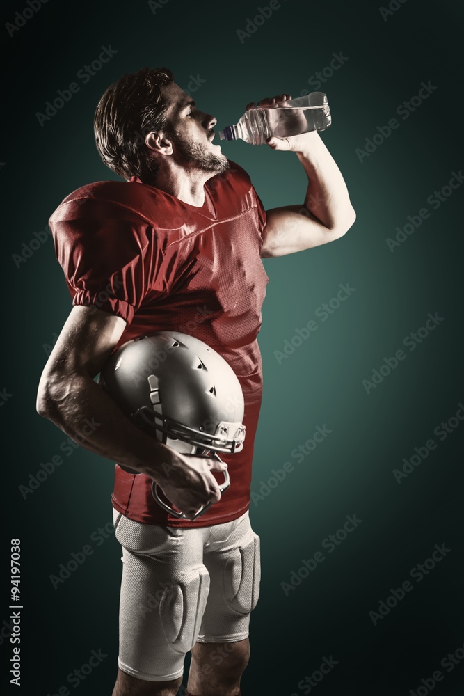 Composite image of american football player drinking