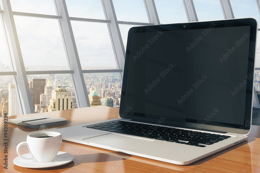 Blank screen of laptop with cup of coffee and diary on a wooden