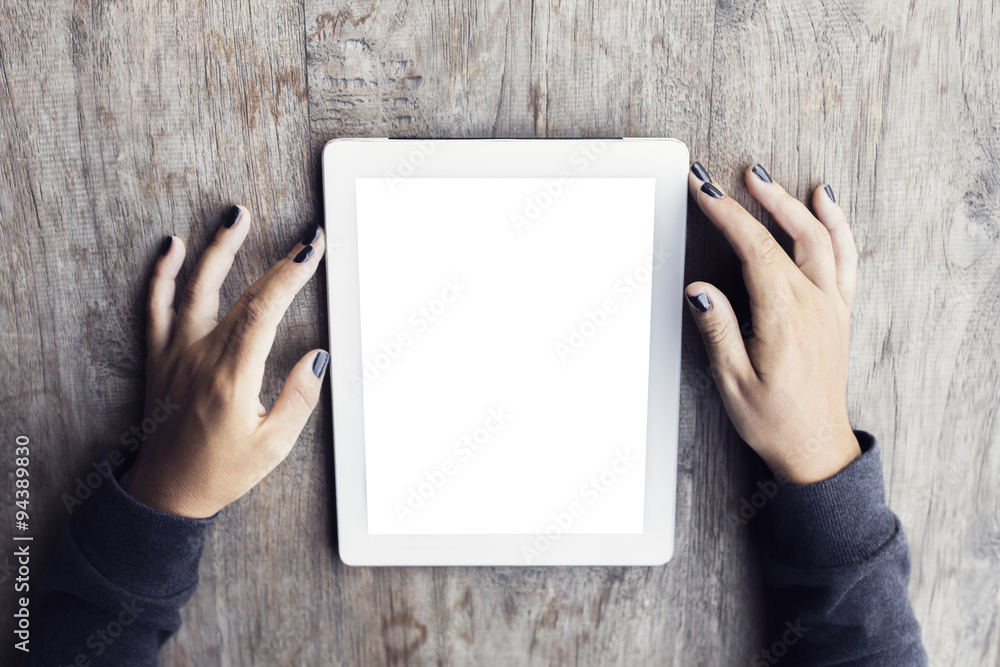 Girl with a blank digital tablet on a wooden table, mock up