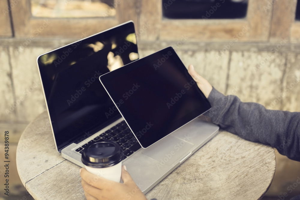 Woman with blank digital tablet, laptop and cup of coffee outdoo