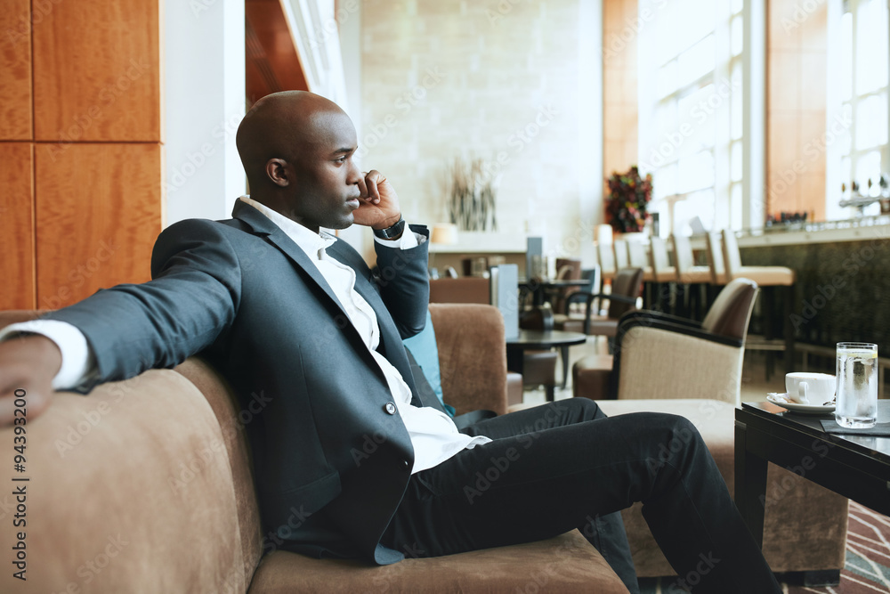 Young businessman at hotel lobby making a phone call