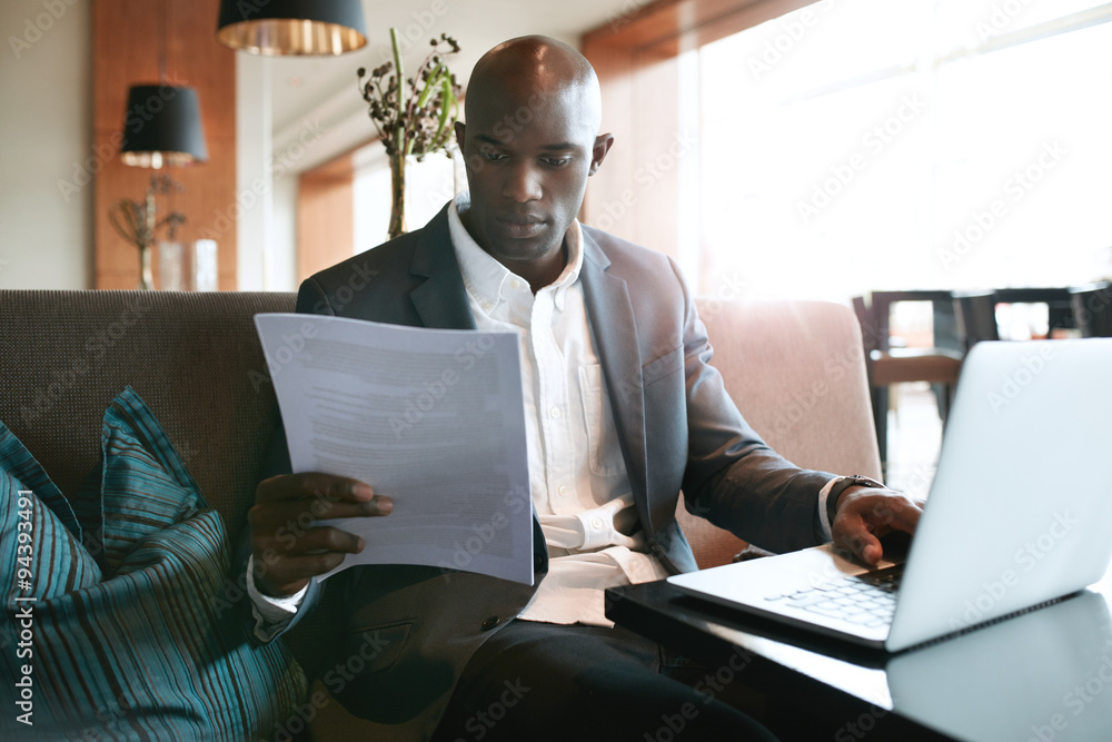 Businessman at cafe preparing himself for a meeting