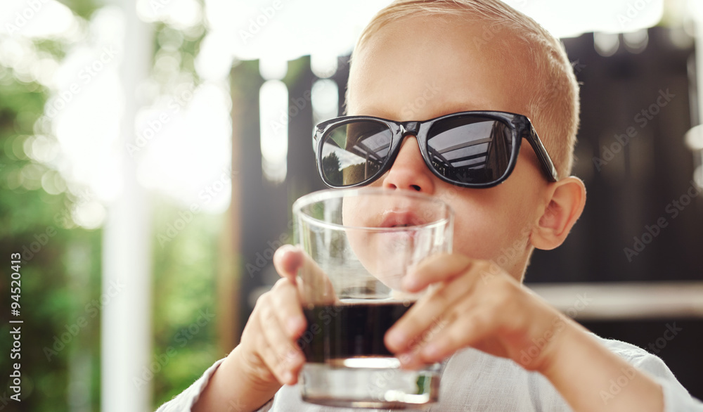 Cute hipster little boy in over sized sunglasses