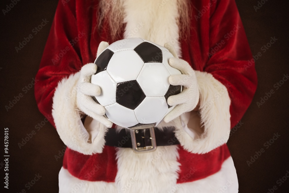 Composite image of santa holds a classic football 