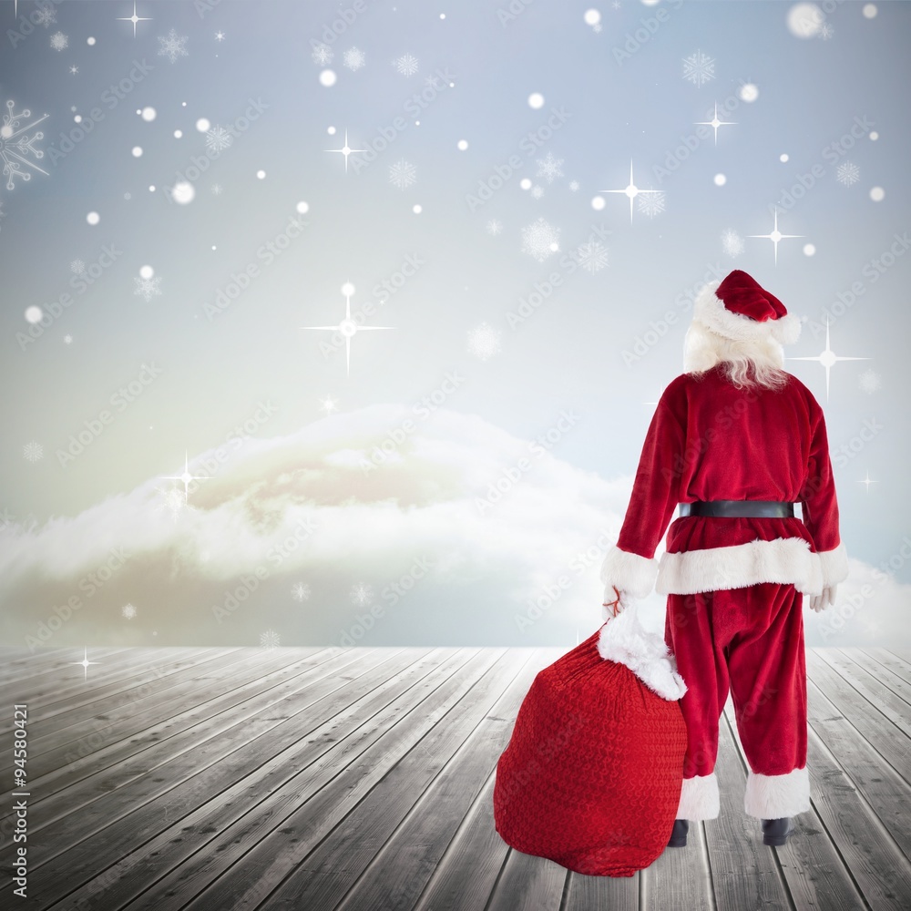 Composite image of santa with sack of gifts