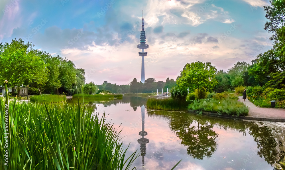 Idyllic evening at Planten um Blomen park with Heinrich-Hertz-Turm at sunset, Hamburg, Germany