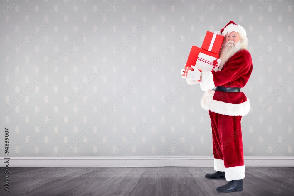 Composite image of santa carrying gifts