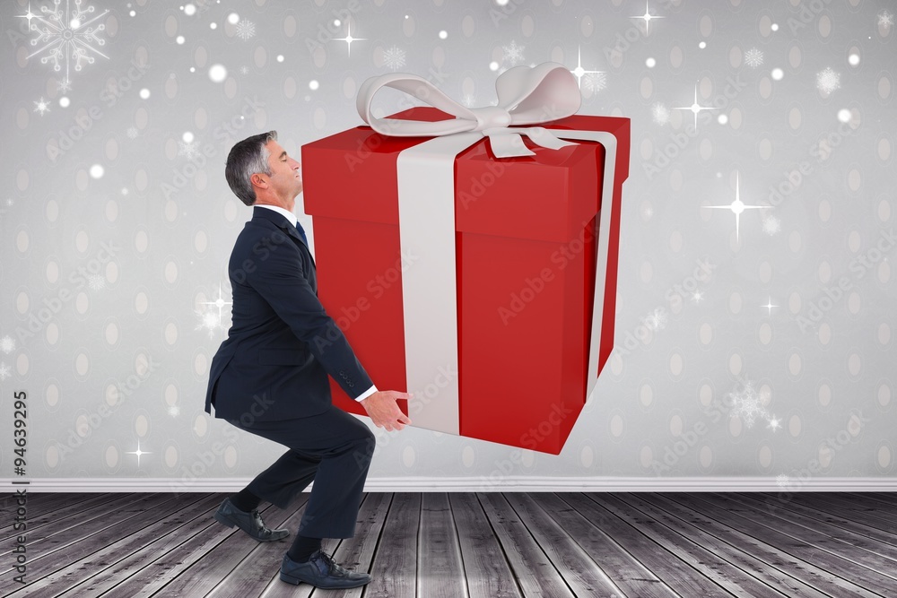 Composite image of stylish man with giant gift