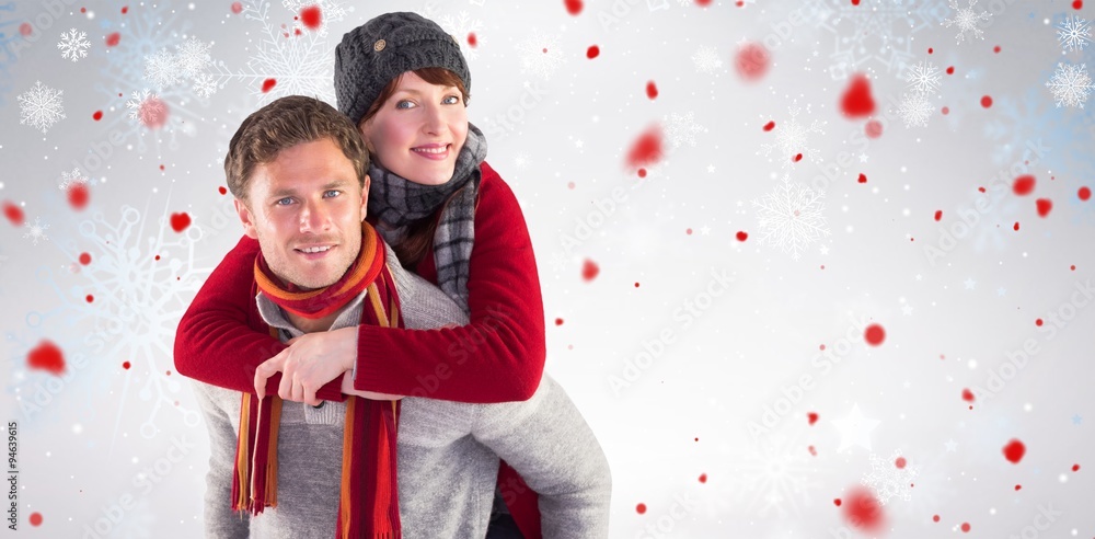 Composite image of man giving girlfriend piggy back