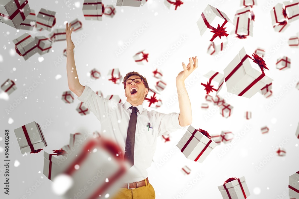 Composite image of geeky businessman standing with arms raised