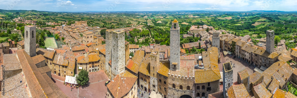 Medieval town of San Gimignano with Tuscan countryside on a sunny day, Tuscany, Italy