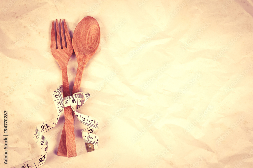 vintage color wooden fork and spoon tied with Measuring tape