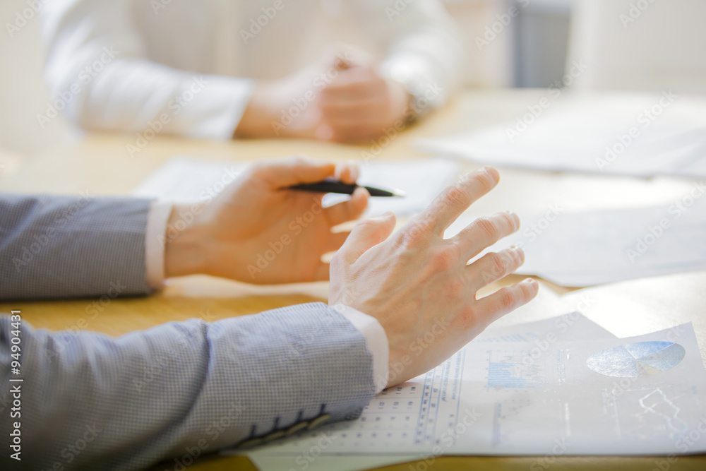 hands of businessman working with laptop during a meeting in the hall of the business 