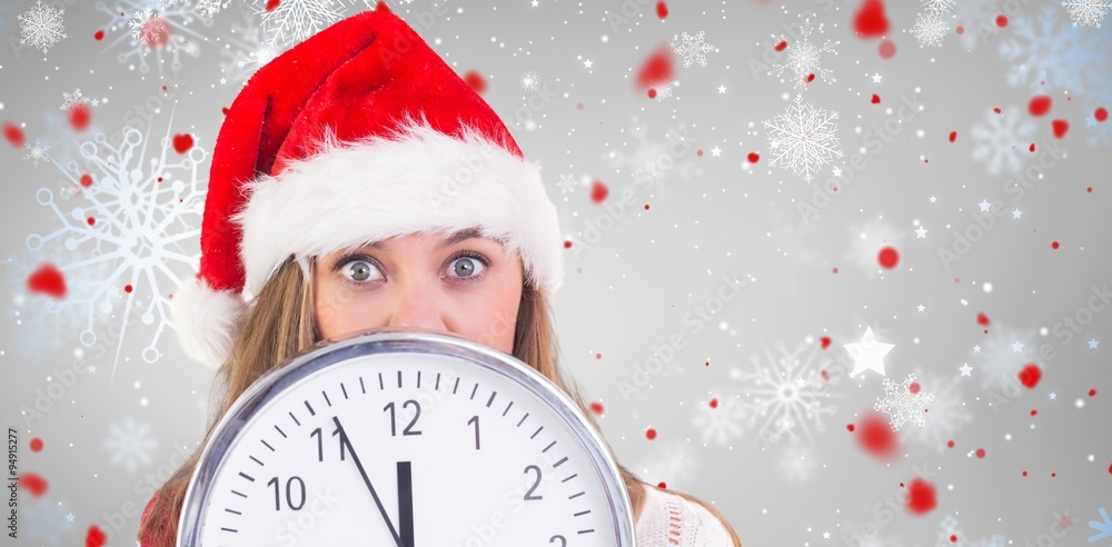 Composite image of festive blonde showing a clock