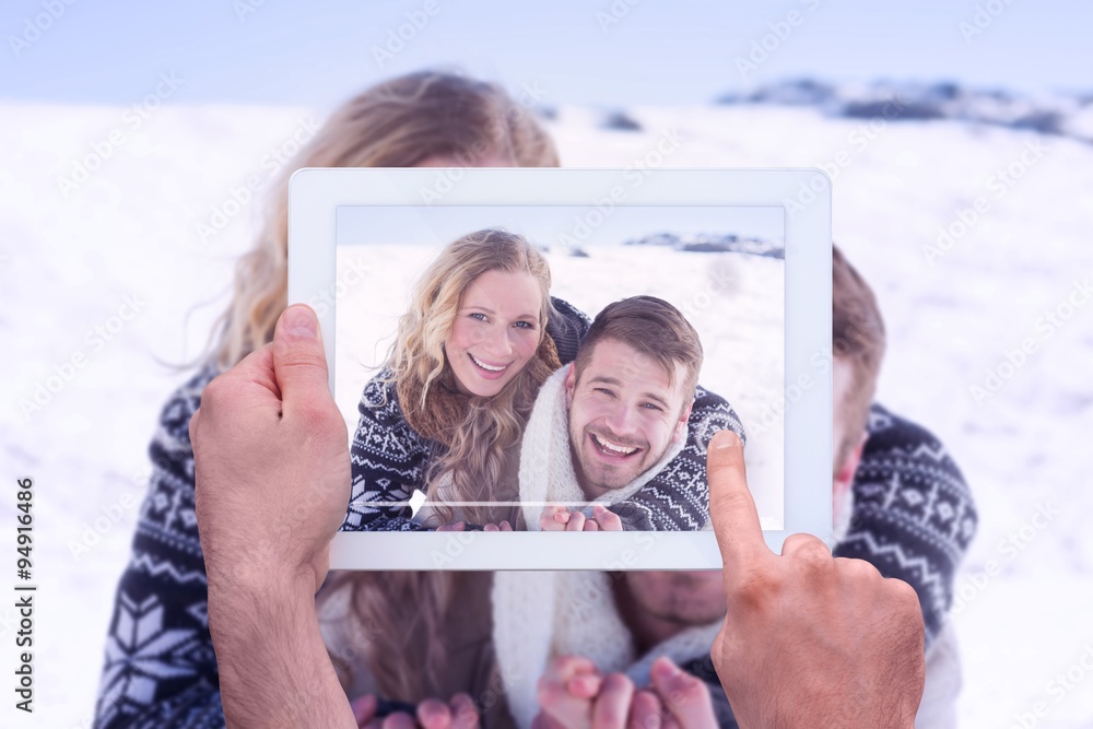 Composite image of hand holding tablet pc