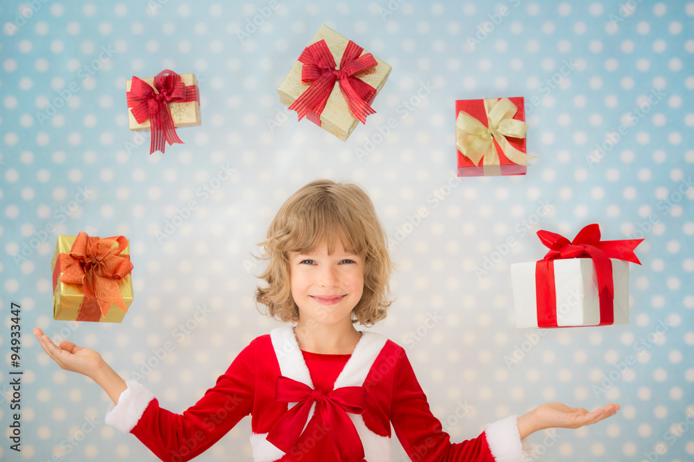 Child juggling Christmas gift boxes