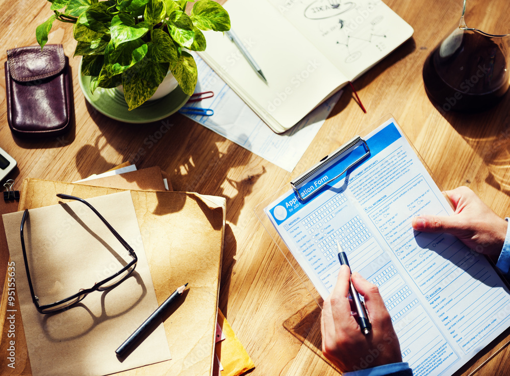 Businessman Filling Up Form on Office Desk Concept