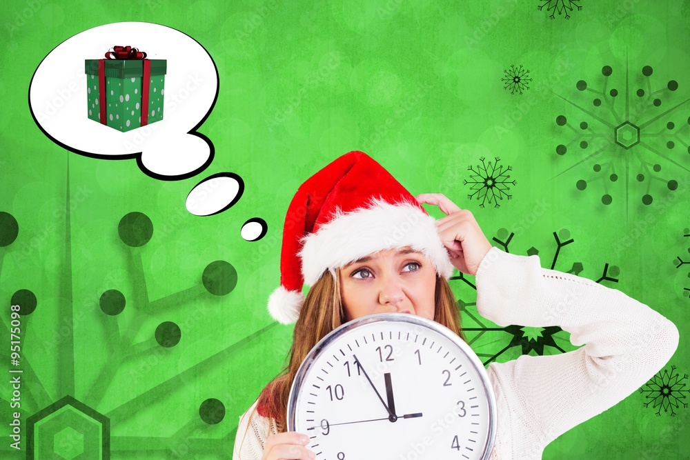 Composite image of festive blonde showing a clock