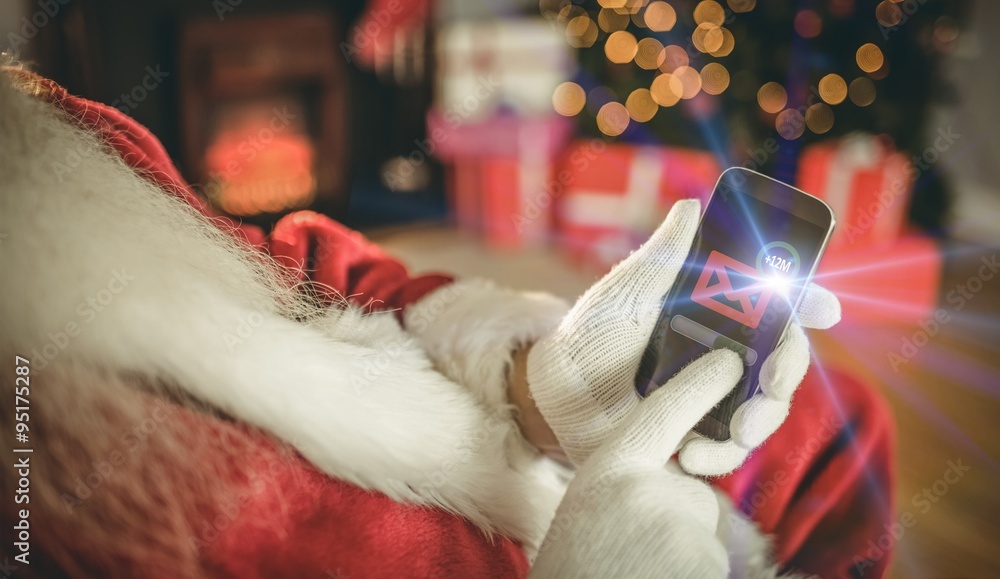 Santa claus touching a smartphone at christmas