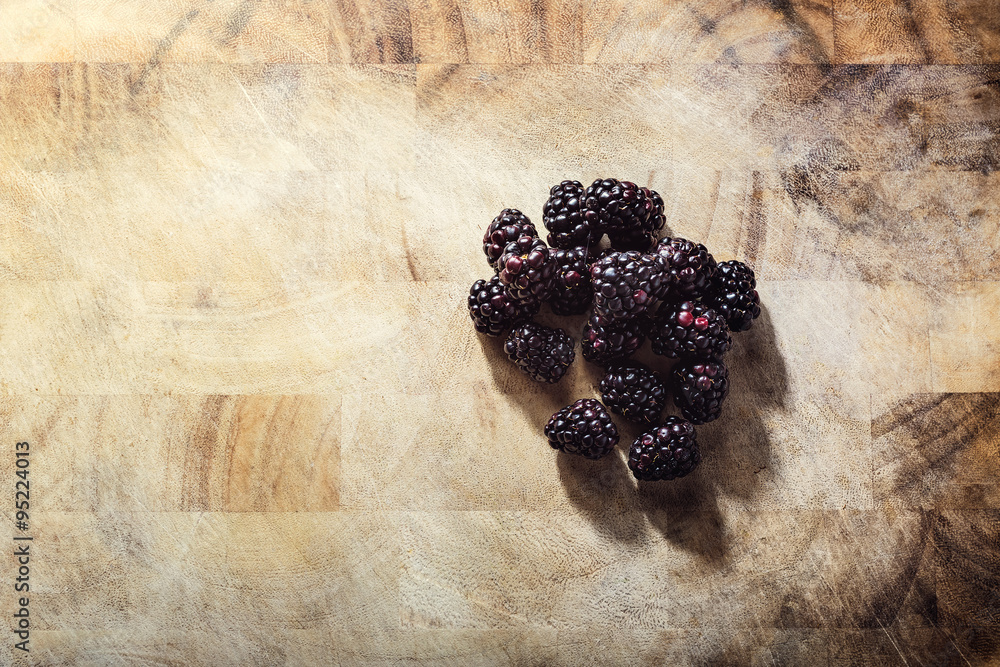 Group of blackberries on a wooden table