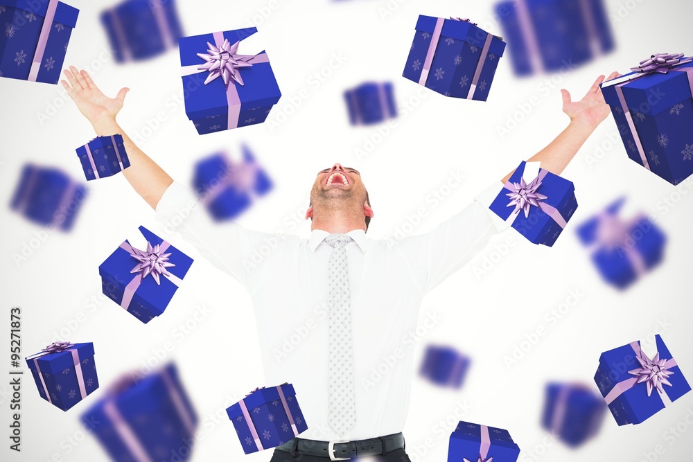 Composite image of handsome businessman cheering with arms up