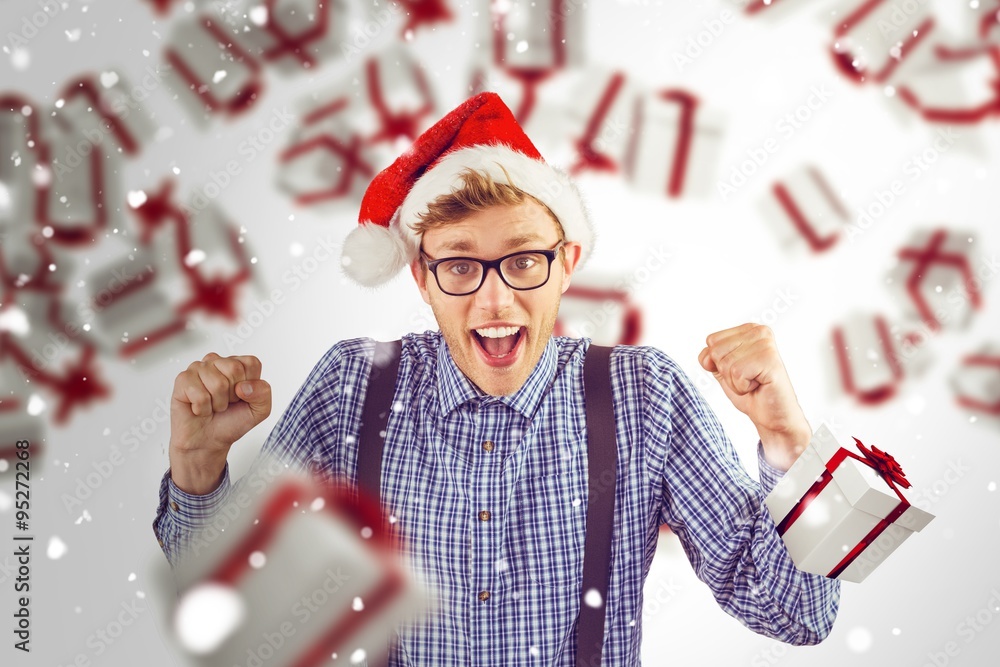 Composite image of geeky hipster wearing santa hat