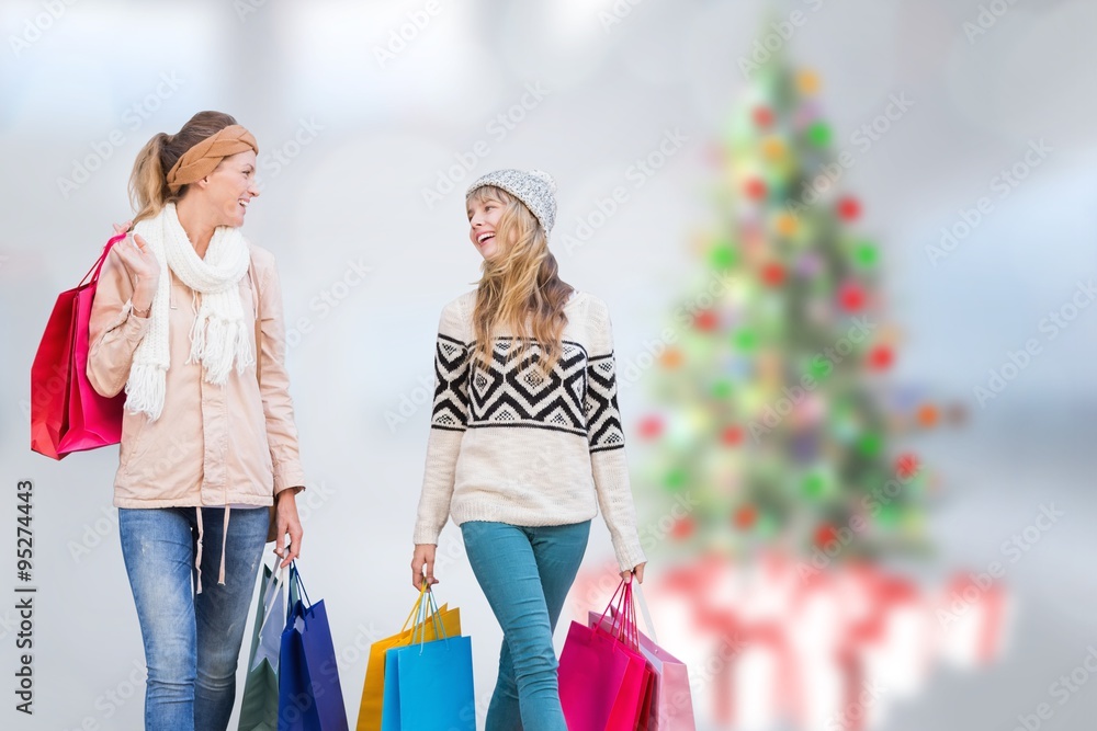 Composite image of beautiful women holding shopping bags