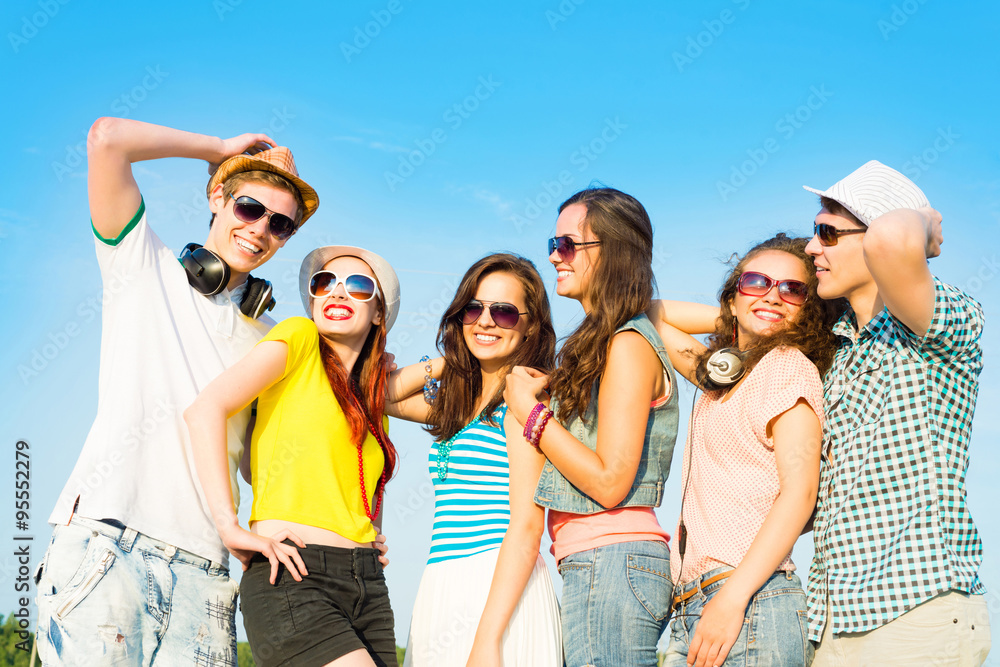 group of young people wearing sunglasses and hat