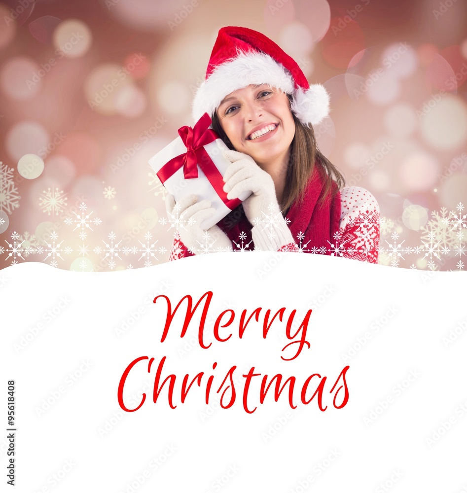 Composite image of attractive woman wearing santa hat with gift