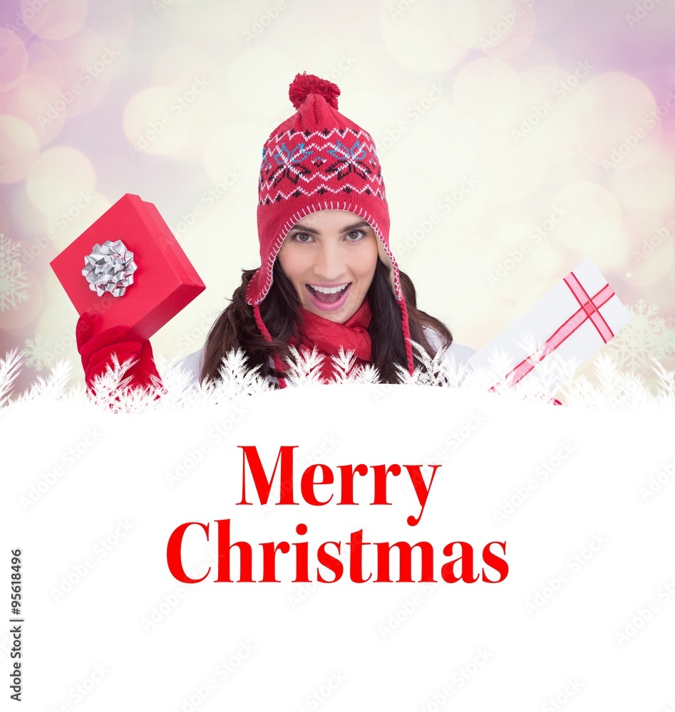 Festive brunette in winter clothes holding gift