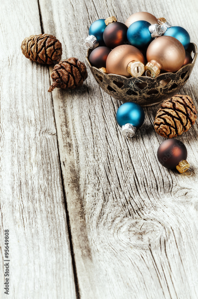 Various Christmas balls on wooden background