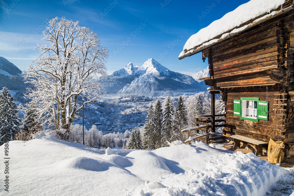 Winter wonderland in the Alps with traditional mountain chalet