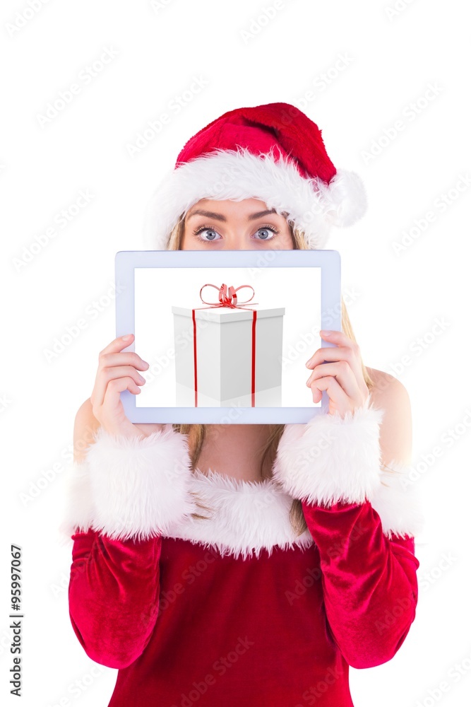 Composite image of pretty santa girl holding tablet