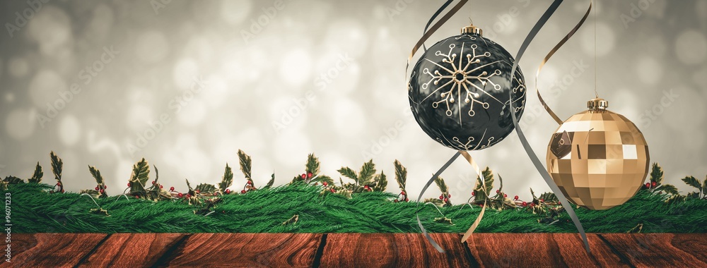 Composite image of hanging christmas bauble decorations