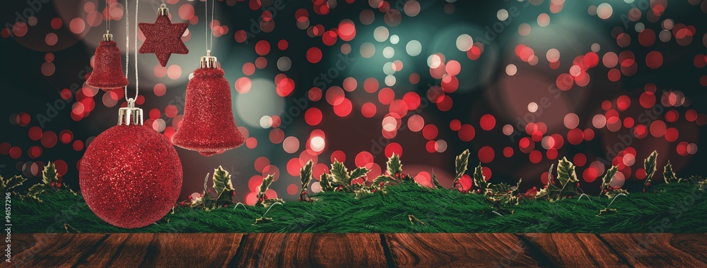 Composite image of red christmas bell decoration hanging 