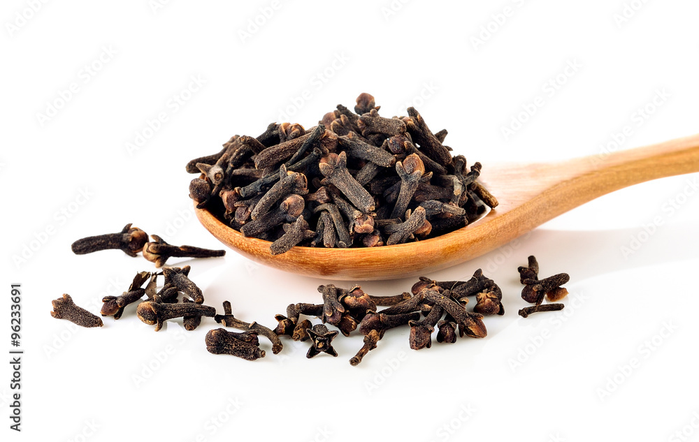 Spice cloves in the spoon on white background